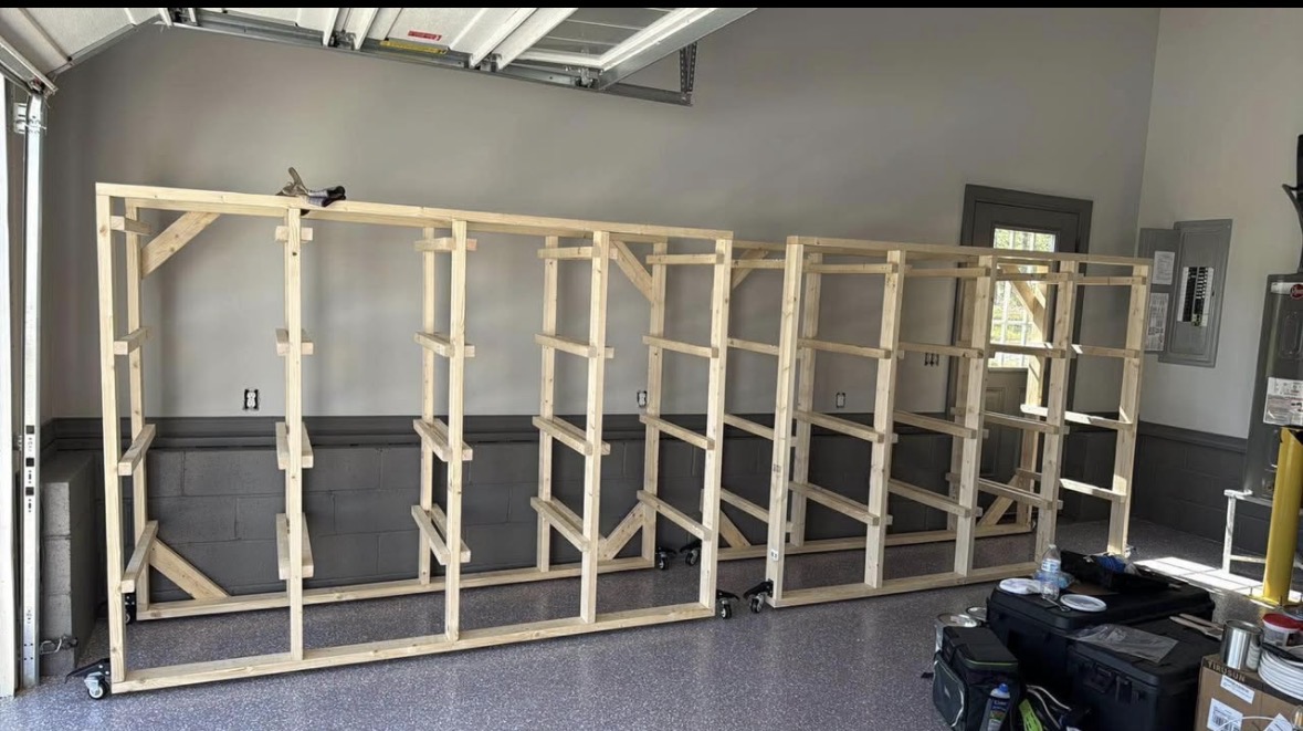Large custom wood Tote Wall frame being installed along a Cabarrus County garage wall